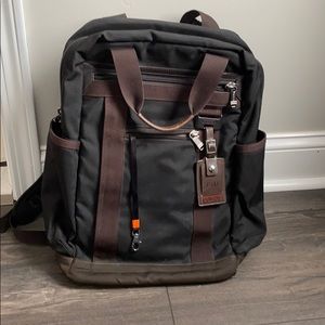 Black with brown leather accent Tumi backpack
